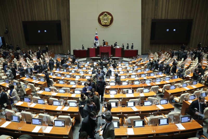 여야 의원들이 24일 새벽 서울 여의도 국회에서 열린 본회의를 마친 뒤 퇴장하고 있다. 뉴스1 제공.