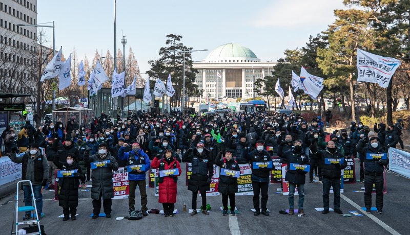 전국공공운수사회서비스노조 조합원들이 28일 오후 서울 여의도 국회 앞에서 결의대회를 열고 민영화금지법 제정, 노조법 2·3조 개정을 촉구하고 안전운임제 사수를 결의하고 있다. 2022.12.28/뉴스1 ⓒ News1 이승배 기자