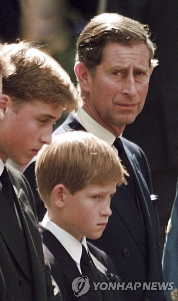 1997년 다이애나빈 장례식 당시 찰스 3세와 두 왕자 FILE - Britain's Prince Charles, the Prince of Wales and his sons Prince William, left and Prince Harry wait for the coffin of Princess Diana to be loaded into a hearse outside of Westminster Abbey, in London on Sept. 6, 1997. An explosive memoir reveals many facets of