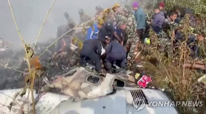 Rescuers work at the site of a plane crash in Pokhara, Nepal January 15, 2023, in this screen grab taken from a handout video. ANI/Handout/via REUTERS ATTENTION EDITORS - THIS IMAGE HAS BEEN SUPPLIED BY A THIRD PARTY. INDIA OUT. NO COMMERCIAL OR EDITORIAL SALES IN INDIA