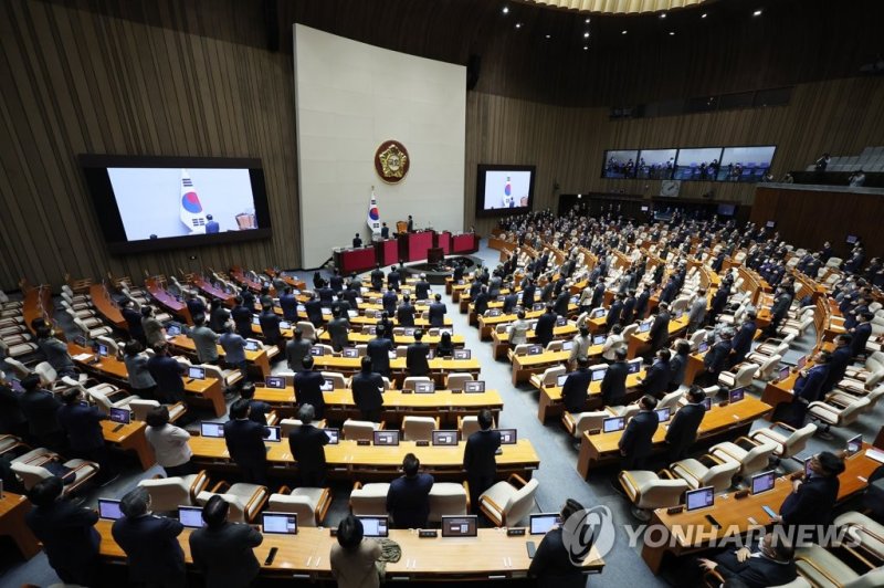 지난 2일 오후 국회 본회의장에서 열린 제403호 국회(임시회) 개회식에서 의원들이 국기에 경례하고 있다. 연합뉴스