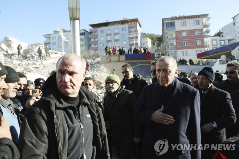 Turkey's President Recep Tayyip Erdogan visits the city center destroyed by Monday earthquake in Kahramanmaras, southern Turkey, Wednesday, Feb. 8, 2023. Thinly stretched rescue teams worked through the night in Turkey and Syria, pulling more bodies from the rubble of thousands of buildings toppled 