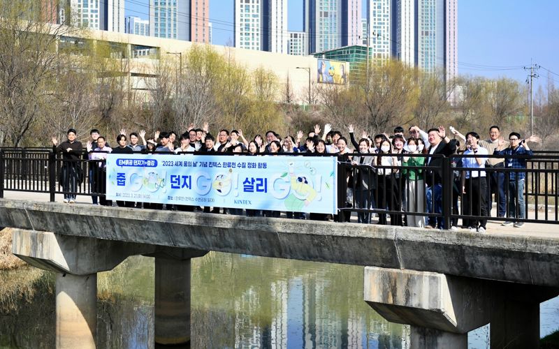 21일 경기 고양시 한류쳔의 수질개선을 위해 EM흙공 던지기 행사를 진행하고 있는 킨텍스 임직원들. 사진=킨텍스