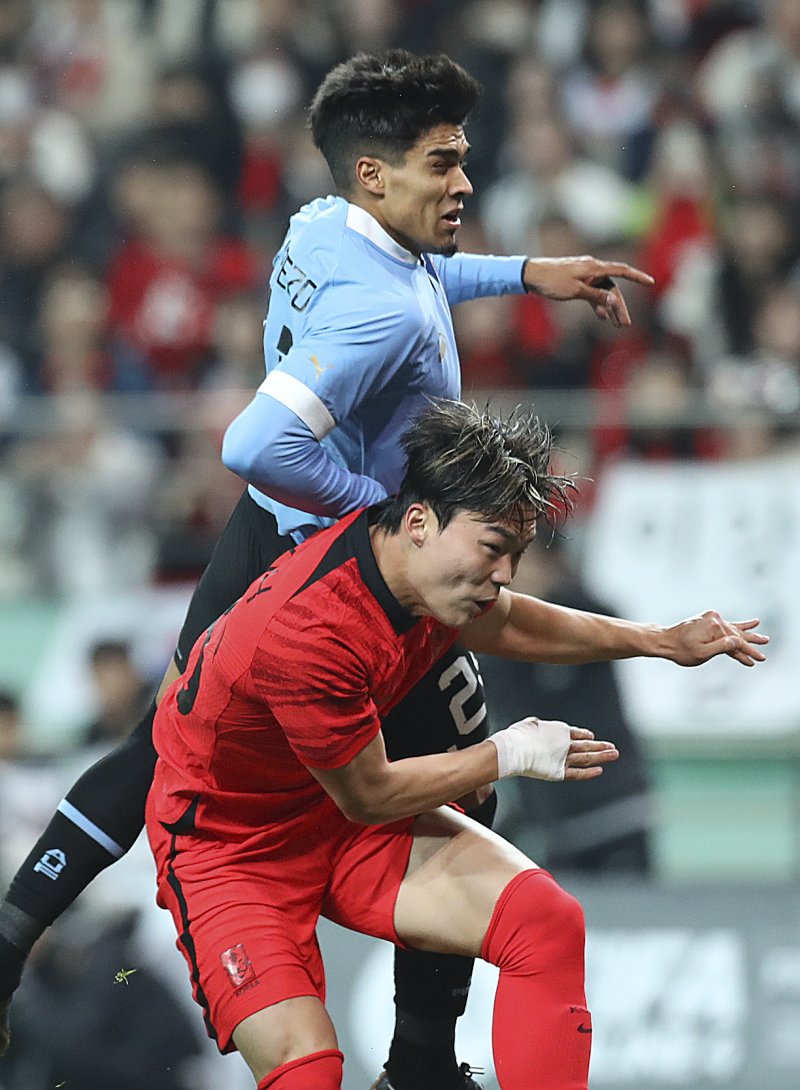 [서울=뉴시스] 최진석 기자 = 28일 오후 서울 마포구 서울월드컵경기장에서 열린 하나은행 초청 축구 국가대표 평가전 대한민국과 우루과이의 경기. 대한민국 오현규가 우루과이 마티아스 아레소와 헤더 경합을 하고 있다. 2023.03.28. myjs@newsis.com