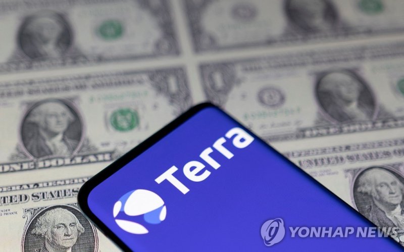 FILE PHOTO: Smartphone with Terra logo is placed on displayed U.S. dollars in this illustration taken May 11, 2022. REUTERS/Dado Ruvic/Illustration/File Photo