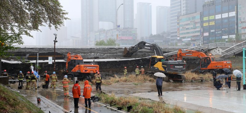 5일 오전 경기 성남시 분당구 정자동 정자교 보행로 일부 구간과 난간이 붕괴되는 사고가 발생, 소방 대원 등이 분주히 현장을 수습하고 있다. 이 사고로 30대 여성 A씨가 숨지고 30대 남성 B씨는 중상을 입어 병원에서 치료 중이다.