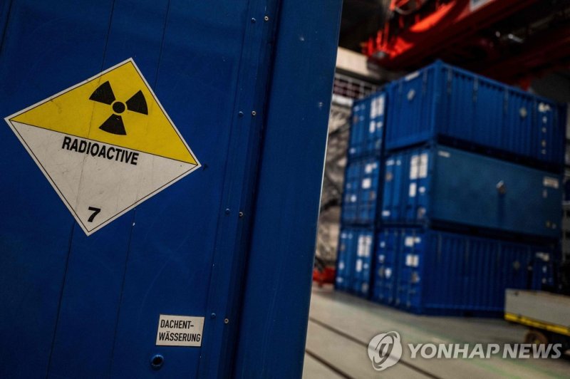 (FILES) This file photo taken on March 16, 2023 shows a label reading "radioactive" is seen on a container in a giant hangar at the EWN Nuclear Power Plant dismantling facility in Lubmin, northeastern Germany. - The former nuclear power plant near Lubmin on Germany's Baltic coast will be dismantled.