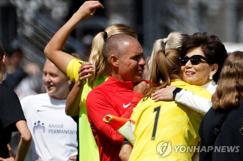 워싱턴 선수들과 포옹하는 미셸 강 구단주 FILE PHOTO: May 6, 2023; Washington, District of Columbia, USA; Washington Spirit goalkeeper Aubrey Kingsbury (1) hugs Spirit owner Michele Kang (R) after the match against San Diego Wave FC at Audi Field. Mandatory Credit: Geoff Burke-USA TODAY Sports/File Photo