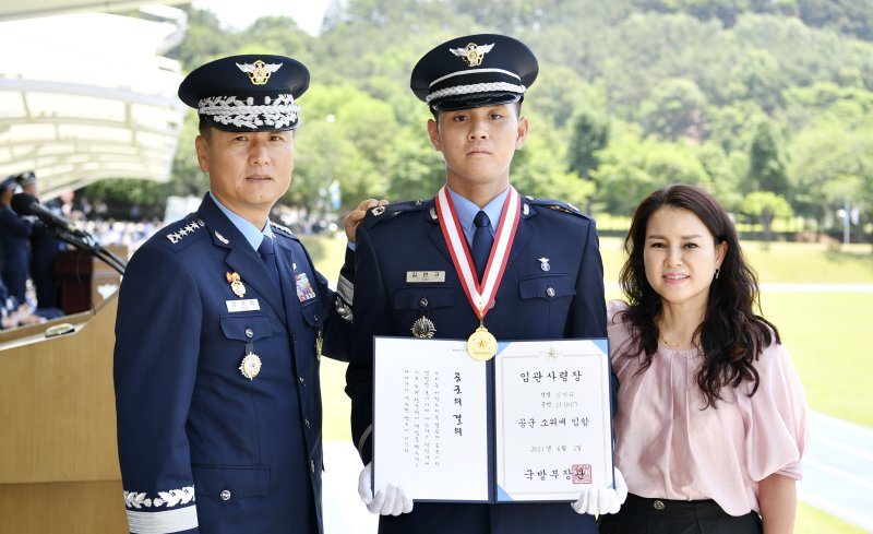 31일 경남 진주시 공군교육사령부에서 정상화 공군참모총장 주관으로 열린 '제150기 학사사관후보생 임관식'에서 임관자 대표 김만규 소위(가운데)가 정상화 공군참모총장(왼쪽)과 가족에게 계급장을 수여받은 후 임관사령장을 들어 보이며 기념 촬영하고 있다. 사진=공군 제공