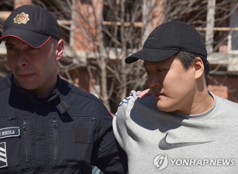 epa10540912 Police officers escort South Korean crypto mogul Do Kwon (R) in Podgorica, Montenegro, 24 March 2023. Do Kwon is wanted in South Korea, Singapore and the USA for the involvement in the collapse of his company Terraform, which is estimated to have cost investors more than 40 billion US do