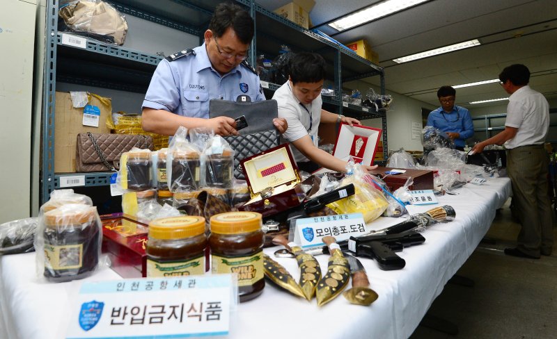 [서울=뉴시스]김진아 기자 = 인천공항세관 직원들이 인천 중구 운서동 인천공항세관 체화창고에서 고가의 해외유명상표 가방, 시계 등 면세범위 초과로 유치된 물품과 총포 및 도검, 히말라야 석청 등 반임금지물품을 감정하고 있다. 2023.06.11. bluesoda@newsis.com