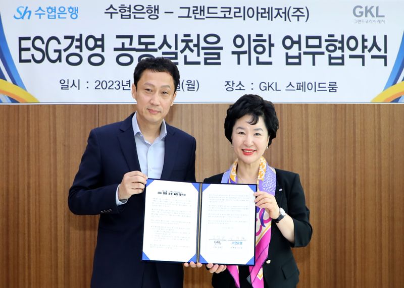 강신숙 수협은행장(오른쪽)과 김영산 그랜드코리아레저 사장이 지난 19일 서울 강남구 GKL 본사에서 '사회적 책임 이행 및 ESG경영 공동실천을 위한 업무협약'을 체결하고 기념촬영을 하고 있다. Sh수협은행 제공