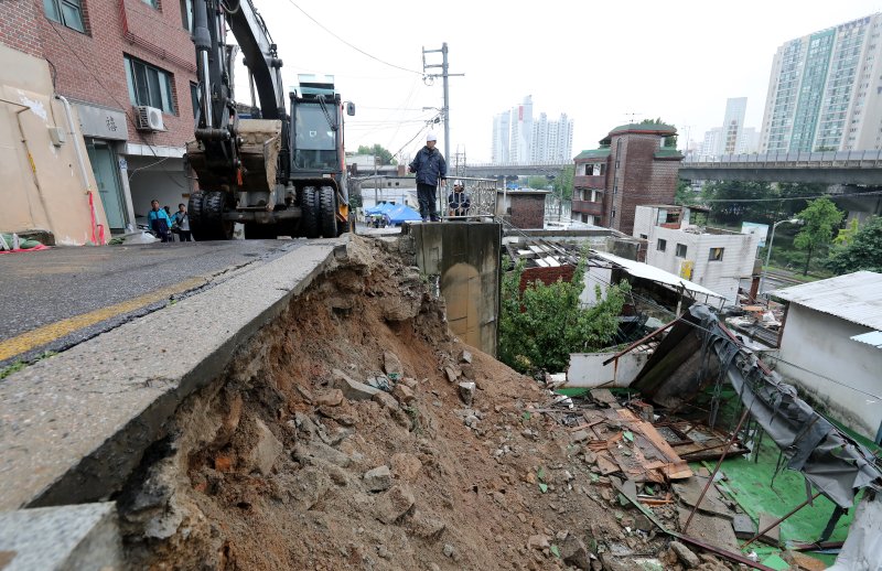 14일 서울 서대문구 연희동에서 구청 관계자들이 지난밤 폭우로 무너진 축대를 복구하고 있다. 이 사고로 인근 20가구 46명이 심야에 긴급 대피했다. 2023.7.14/뉴스1 ⓒ News1 박지혜 기자