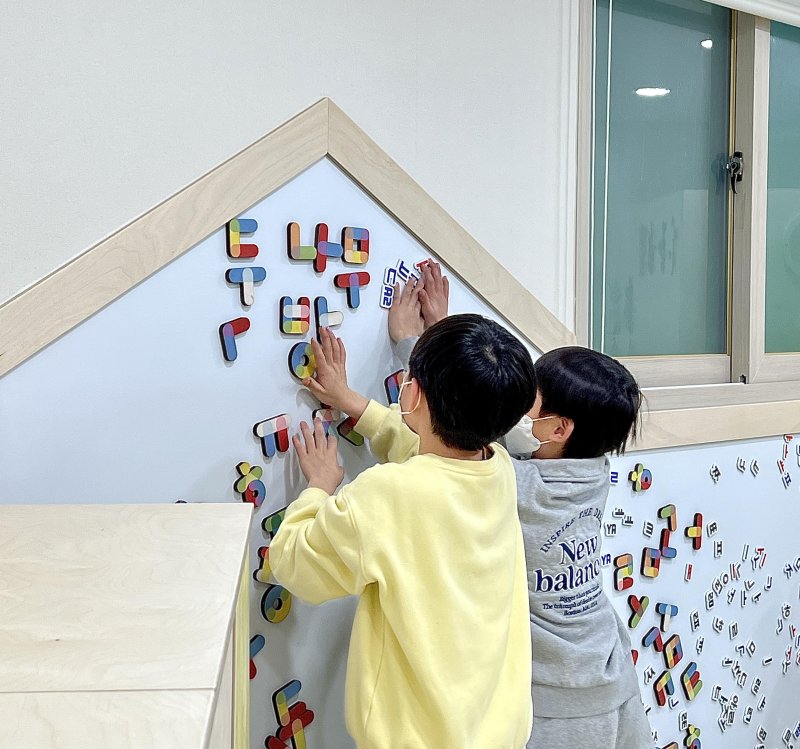 아동 언어발달 놀이공간으로 조성된 '두나무방 1호'에서 아이들이 한글 모양 자석을 갖고 놀이를 하고 있다.