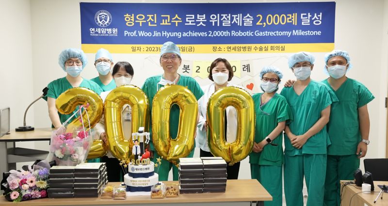 연세암병원 위암센터 형우진 교수(왼쪽 네번째)가 지난 18일 세계 최초로 2000번째 위암 로봇수술을 성공적으로 마치고 의료진들과 함께 기념 사진 촬영을 위한 포즈를 취하고 있다. 세브란스병원 제공