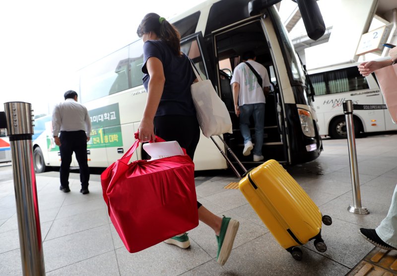 [서울=뉴시스] 김진아 기자 = 추석 연휴를 하루 앞둔 27일 서울 서초구 서울고속버스터미널에서 귀성객들이 짐을 들고 버스를 타고 있다. 2023.09.27. bluesoda@newsis.com