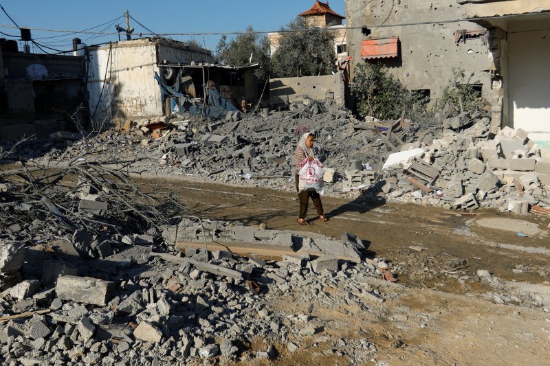 15일(현지시간) 한 여성이 가자지구 남부 칸 유니스에서 이스라엘의 공습으로 무너진 건물 사이를 걷고 있다. 23.10.15 ⓒ 로이터=뉴스1 ⓒ News1 김예슬 기자