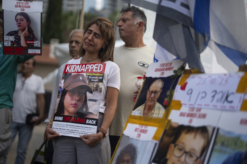 23일(이하 현지시간) 이스라엘 텔아비브에서 지난 7일 하마스의 공격으로 납치된 가족들의 석방을 요구하는 시위대가 팻말을 들고 있다. AP뉴시스