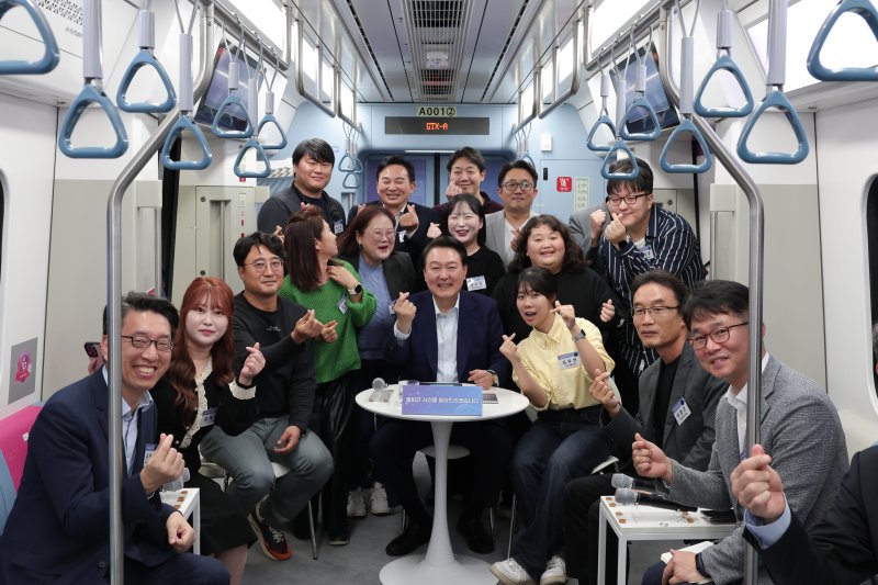 윤석열 대통령이 6일 경기도 화성시 동탄역 GTX-A 열차에서 열린 광역교통 국민 간담회에서 참석자들과 기념촬영을 하고 있다. (대통령실 제공) 2023.11.6/뉴스1 ⓒ News1 오대일 기자