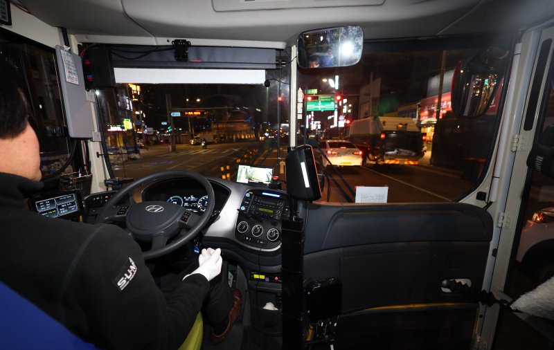 [서울=뉴시스] 최진석 기자 = 4일 서울 종로구 동대문역.흥인지문 버스정류장에서 출발한 '심야A21번' 심야자율버스 운전자가 운전대에서 손을 놓고 있다. 2023.12.05. myjs@newsis.com