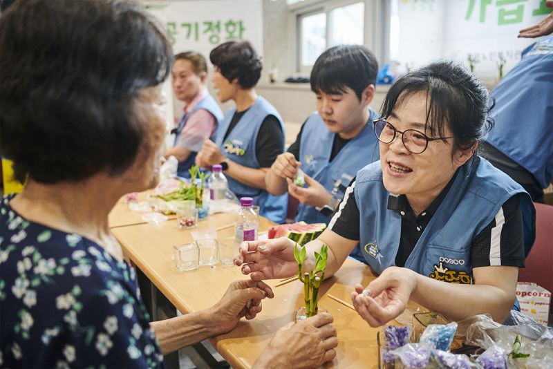 포스코 봉사단이 전남 광양 태인동에서 어르신들과 함께 공기정화 식물을 만들고 있다. 포스코 제공