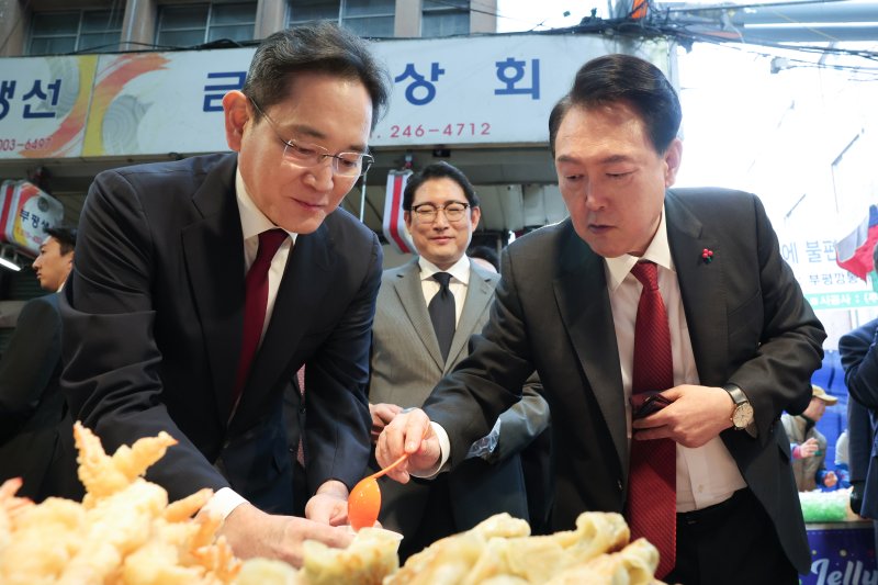 윤석열 대통령이 6일 부산 중구 깡통시장을 방문해 이재용 삼성전자 회장 등 기업인들과 분식을 시식하고 있다. 뉴스1