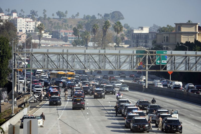 Police state on the 110 freeway after pro-Palestinian protesters blocked in during the morning commute Wednesday, Dec. 13, 2023, in Los Angeles. (AP Photo/Marcio Jose Sanchez)
