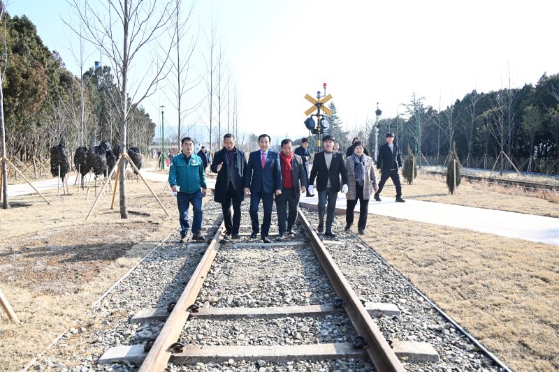 [울산=뉴시스] 박수지 기자 = 울산시 북구가 30일 폐선부지 울산숲 1·2구간 준공식을 연 가운데 박천동 북구청장과 시·구의원 등이 울산숲 내 철도 레일을 복원한 구간을 걷고 있다. (사진=북구 제공) 2024.01.30. photo@newsis.com *재판매 및 DB 금지