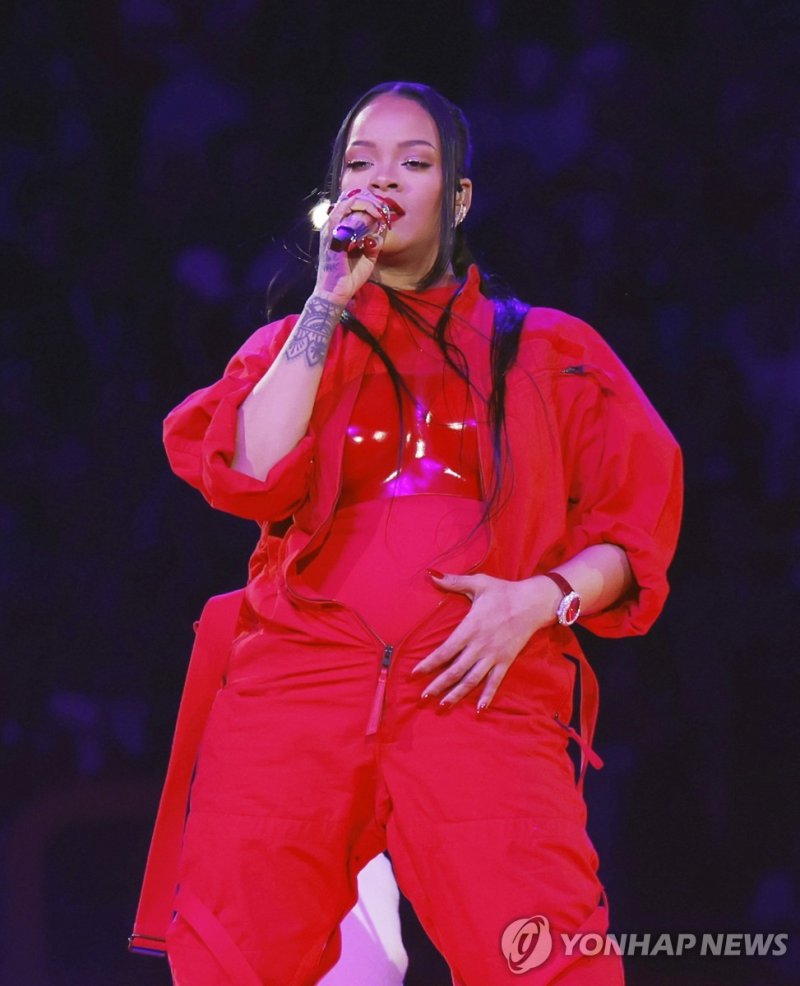 지난해 하프타임 쇼를 지배했던 리애나 Grammy award-winning singer Rihanna reveals a baby bump as she performs during the Super Bowl LVII halftime show after the first half of Super Bowl LVII at State Farm Stadium in Glendale, Arizona, on Sunday, February 12, 2023. Rihanna revealed that she is pregnant following her 