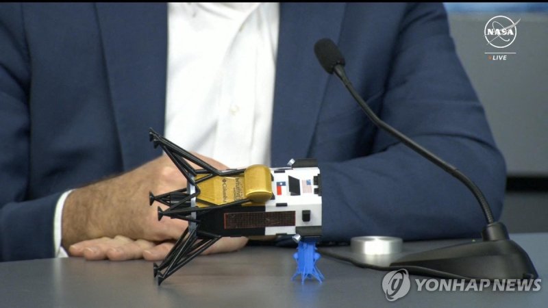 This frame grab from Nasa, shows Intuitive Machines CEO Steve Altemus holding a model of Odysseus to show its position on the side during a press conference at Johnson Space Center in Houstom, Texas on February 23, 2024. The first American spaceship on the Moon since Apollo probably face-planted int