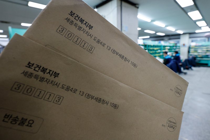 정부가 근무지를 이탈한 전공의들에게 행정처분 사전통지서를 발송한 지난 6일 서울 시내 우체국에서 행정처분 사전통지서 너머로 집배원들이 분류작업을 하고 있다. 2024.3.6/뉴스1 ⓒ News1 안은나 기자