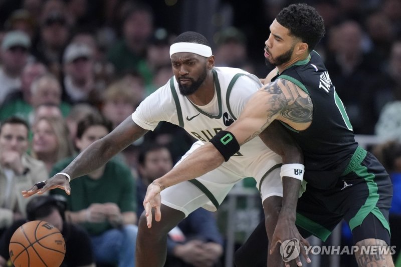 공을 지켜내려는 밀워키의 보비 포르티스 Milwaukee Bucks forward Bobby Portis, left, is defended by Boston Celtics forward Jayson Tatum during the first half of an NBA basketball game, Wednesday, March 20, 2024, in Boston. (AP Photo/Steven Senne)