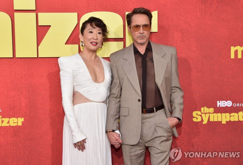 US-Canadian actress Sandra Oh (L) and US actor/executive producer Robert Downey Jr. arrive for HBO?s original limited series premiere of "The Sympathizer" at the Paramount Theatre in Los Angeles, April 9, 2024. (Photo by Chris DELMAS / AFP)
