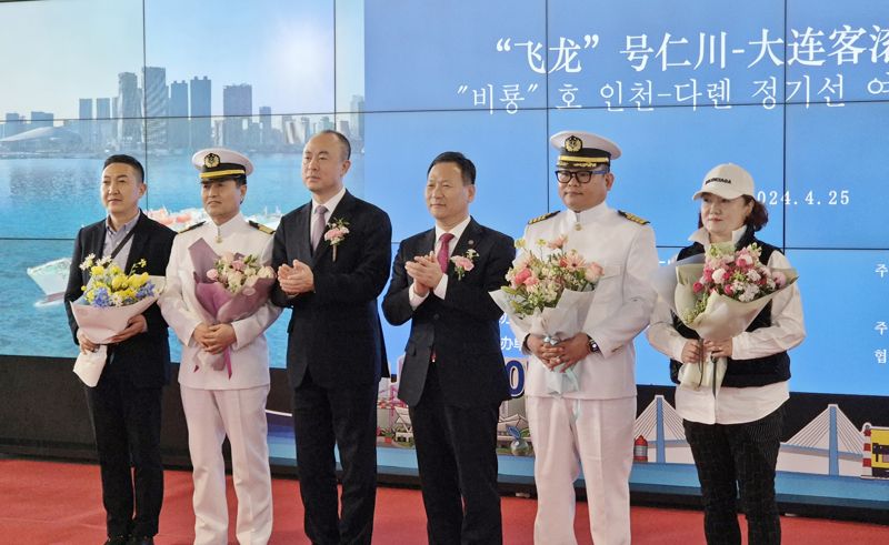 25일 인천항 국제여객터미널에서 인천-대련 항로 재개를 축하하는 의미로 첫 여객과 선장에게 꽃다발을 증정하고 기념촬영을 하고 있다. 인천항만공사 제공.