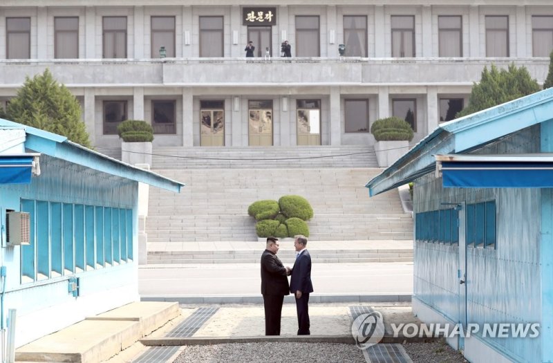 문재인 당시 대통령과 북한 김정은 국무위원장이 지난 2018년 4월 판문점에서 북측 지역으로 넘어가 악수하고 있다. 연합뉴스
