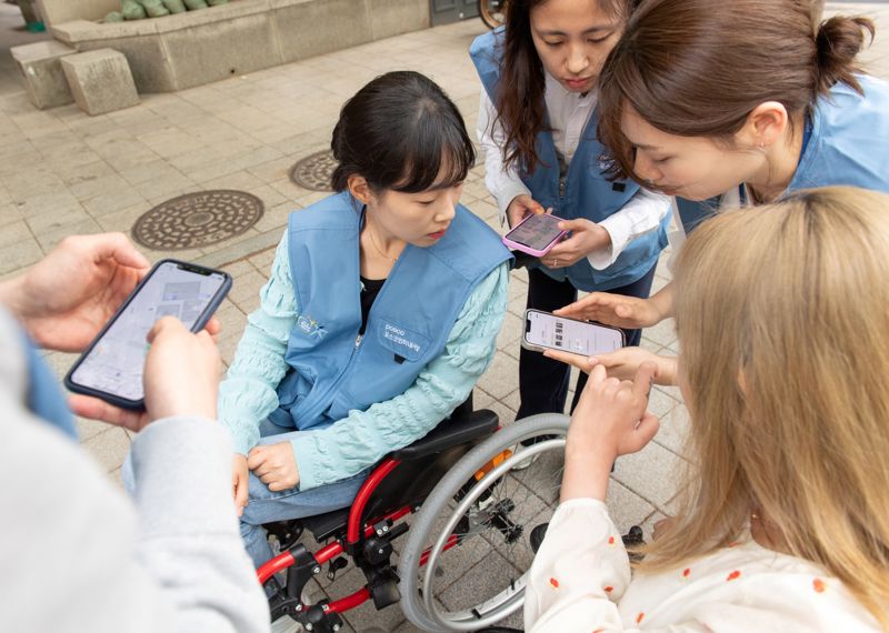 포스코인터내셔널 임직원들이 4월 15~26일 2주 간 휠체어를 타고 다니며 휠체어 사용자 입장을 직접 경험한 정보를 바탕으로 휠비(휠체어 전용 내비게이션) 앱에 적용될 위치 정보를 수집하고 있다. 포스코인터내셔널 제공