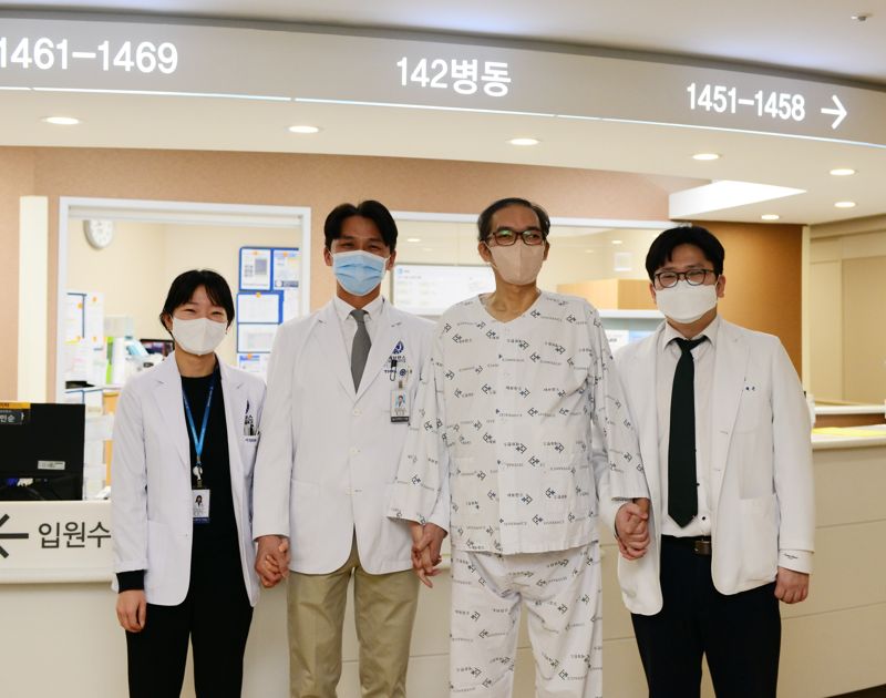 세브란스병원 이식외과 민은기, 한기창, 이재근 교수가 환자(왼쪽 세번째)와 사진 촬영을 하고 있다. 세브란스 제공