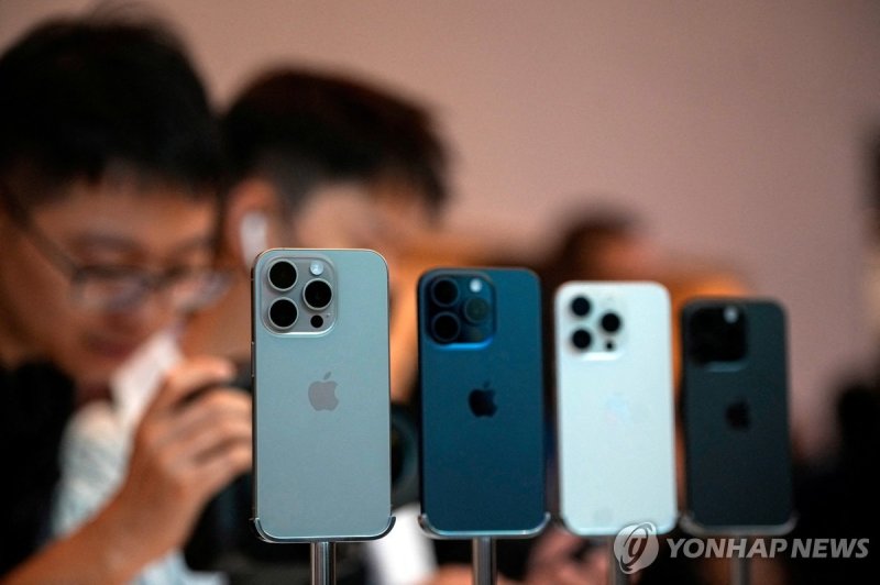 아이폰 FILE PHOTO: People look at the new iPhone 15 Pro as Apple's new iPhone 15 officially goes on sale across China at an Apple store in Shanghai, China September 22, 2023. REUTERS/Aly Song/File Photo