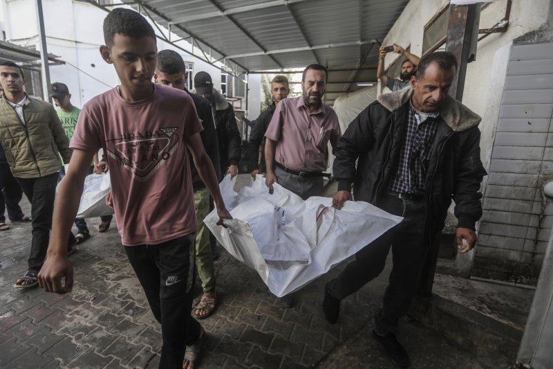 [AP/뉴시스] 3일 가자 팔레스타인 주민들이 전날 밤 라파 공습에 사망한 가족 시신을 옮기고 있다. 차히네 가족으로 어른 2명과 16세 미만 5명이 죽었다.
