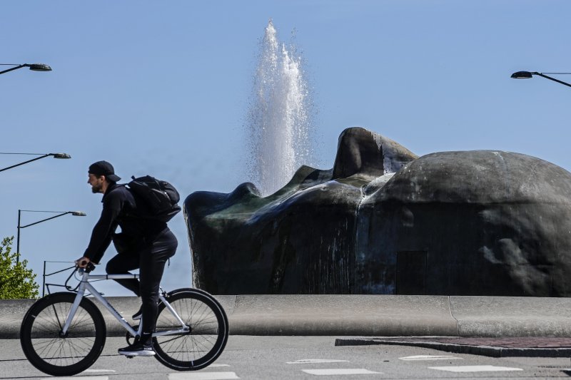 스웨덴 말뫼에서 8일(현지시간) 한 시민이 자전거를 타고 크리스티나 귈렌함마르의 조각상 '어머니' 앞을 지나고 있다. 스웨덴 중앙은행 릭스방크는 이날 기준금리를 0.25%p 인하했다. AP 뉴시스
