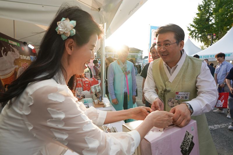 지난 10일 전북 남원에서 열린 '5월 동행축제, 남원 춘향제와 동행' 행사에 오기웅 중소벤처기업부 차관이 소상공인 판매부스를 둘러보고 물건을 구입하고 있다. 중기부 제공