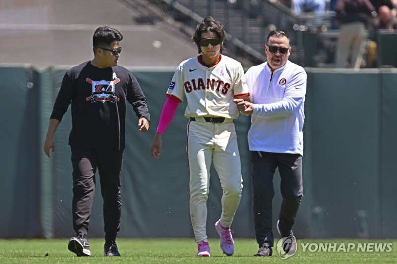 어깨를 다친 이정후 San Francisco Giants' Jung Hoo Lee, center, is escorted to the locker room by a trainer and his translator after an injury in the first inning of a game against the Cincinnati Reds in San Francisco, Sunday, May 12, 2024. (Jose Carlos Fajardo/Bay Area News Group via AP) MANDATORY CREDIT; N