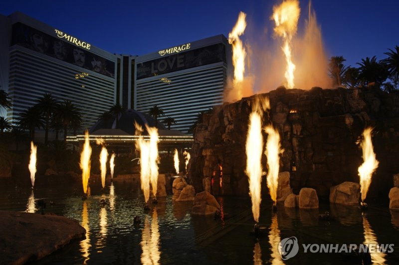 라스베이거스 미라지 호텔의 화산쇼 People watch the Volcano show at the Mirage hotel-casino along the Las Vegas Strip Thursday, May 16, 2024, in Las Vegas. The iconic casino will shut its doors this summer on July 17, 2024, the end of an era for a property credited with helping transform Sin City into an ultra-luxu