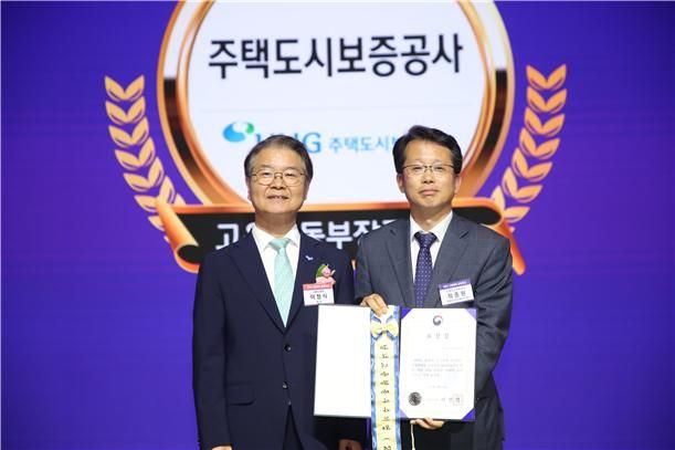 지난 28일 서울 중구 대한상공회의소 국제회의장에서 열린 '2024 고용평등 공헌포상' 시상식에서 최종원 HUG 경영인프라혁신단장(오른쪽)이 이정식 고용노동부장관과 기념촬영을 하고 있다. HUG 제공