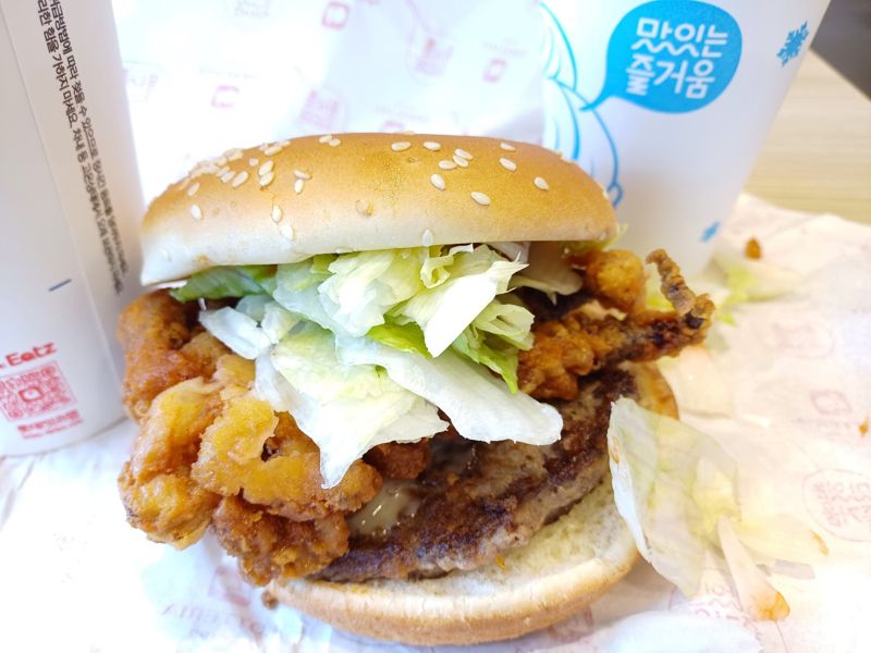롯데리아 신메뉴 오징어 얼라이브 비프 버거. 오징어 다리 튀김이 생각보다 크고, 양배추 역시 풍성하게 들어있다. 버거를 먹던 중 문득 '그 많은 오징어 몸통은 누가 다 먹었을까'라는 생각이 들었다. 사진 이환주 기자.