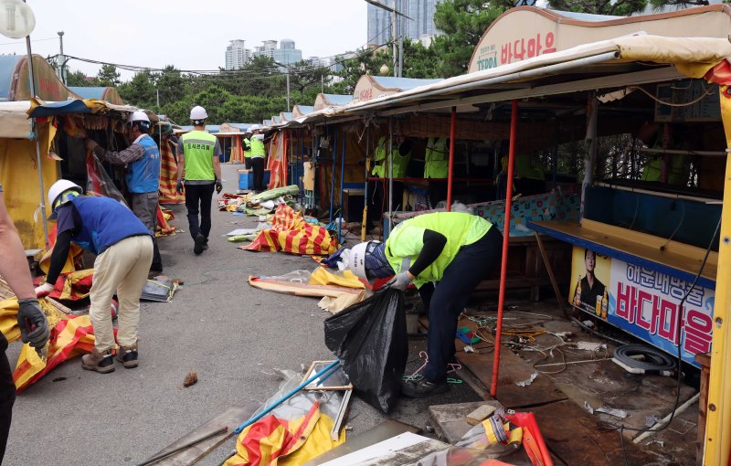 [부산=뉴시스] 하경민 기자 = 1960년대 초부터 영업을 한 부산 해운대 바다마을 포장마차촌이 추억 속으로 사라졌다. 25일 해운대구청 관계자들이 중장비를 동원해 포장마차촌을 철거하고 있다. 이 포장마차촌은 시유지 무단점용과 무신고 영업행위 등 논란이 끊이지 않았고, 해운대구는 2021년 상인들과 2년6개월의 유예기간을 거쳐 올 1월31일 자진 철거하기로 합의하고 이날 최종 철거에 나섰다. 2024.06.25. yulnetphoto@newsis.com