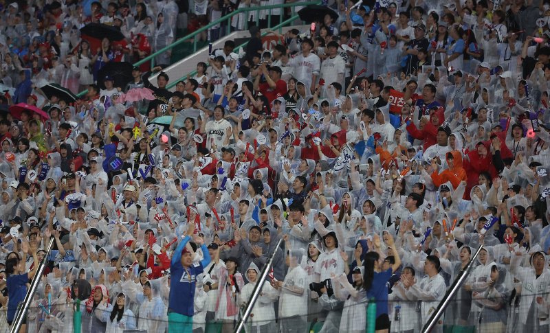 6일 오후 인천 SSG랜더스필드에서 열린 '2024 신한 SOL Bank KBO 올스타전’ 나눔 올스타와 드림 올스타의 경기 9회말 야구팬들이 우산과 우의를 입은 채 열띤 응원을 펼치고 있다. 사진=뉴스1