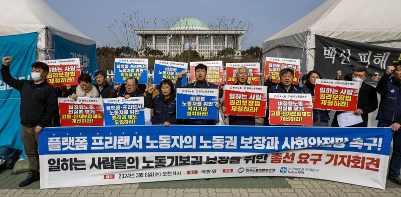 지난 3월 국회 앞에서 열린 한국노총-플랫폼프리랜서노동공제회, 노동기본권 보장 위한 총선 정책요구 기자회견에서 참석자들이 구호를 외치고 있다. <뉴시스>