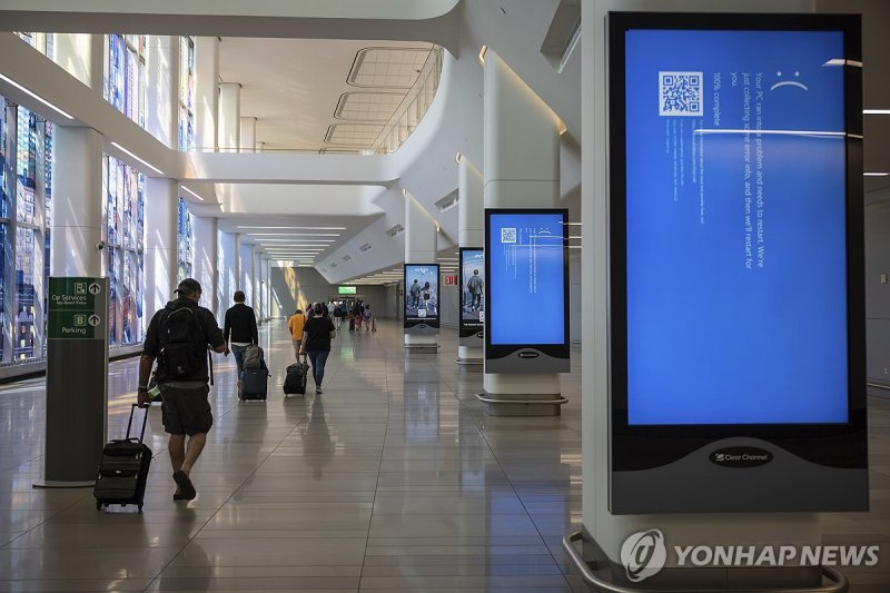 Screens show a blue error message at a departure floor of LaGuardia Airport in New York on Friday, July 19, 2024, after a faulty CrowdStrike update caused a major internet outage for computers running Microsoft Windows. (AP Photo/Yuki Iwamura)