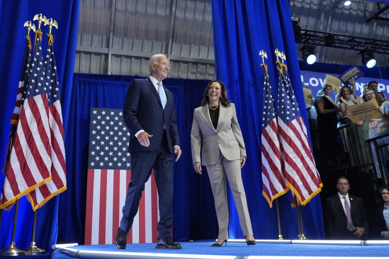 President Joe Biden, left, and Democratic presidential nominee Vice President Kamala Harris arrive to speak about the administration's efforts to lower costs during an event at Prince George's Community College in Largo, Md., Thursday, Aug. 15, 2024. (AP Photo/Susan Walsh)